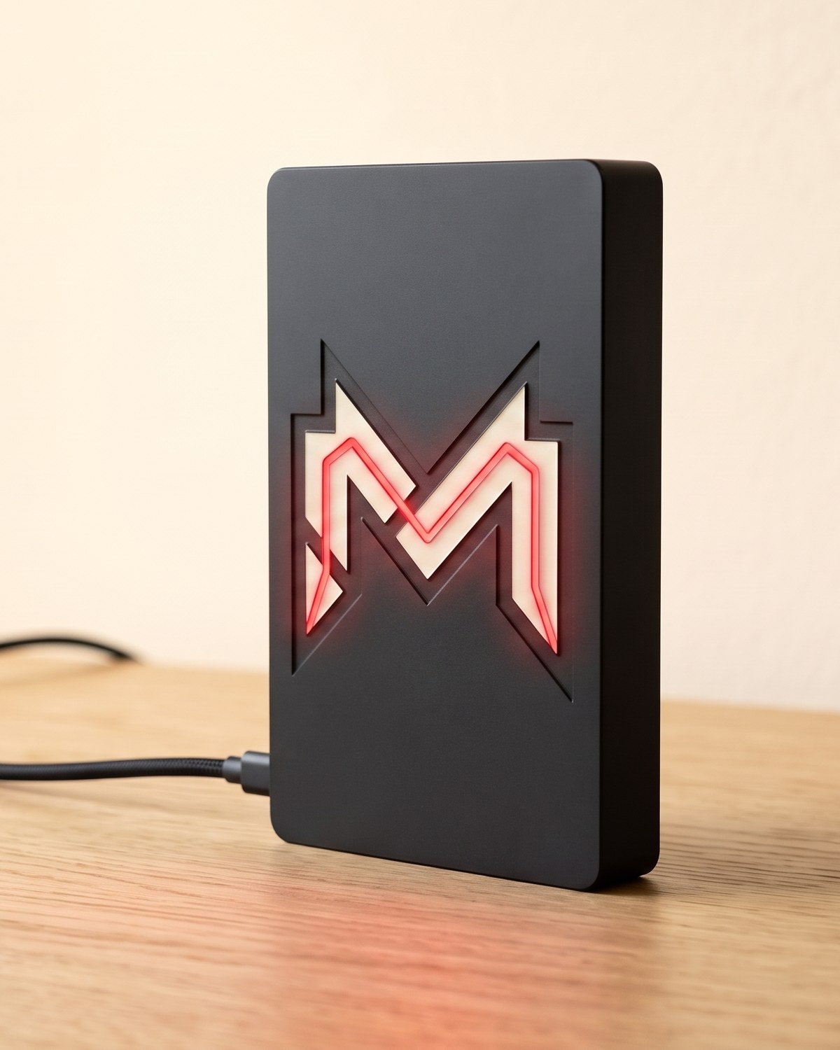 MIND Box on a desk, the MIND M glowing red on its face